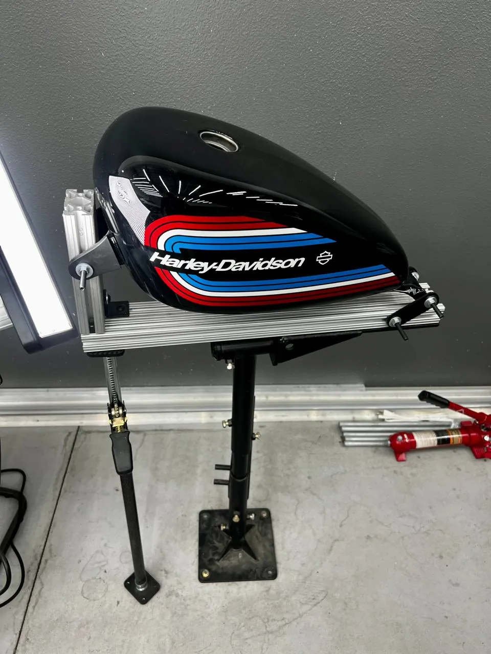 Paintless dent repair in progress on a Harley Davidson tank, Upland California